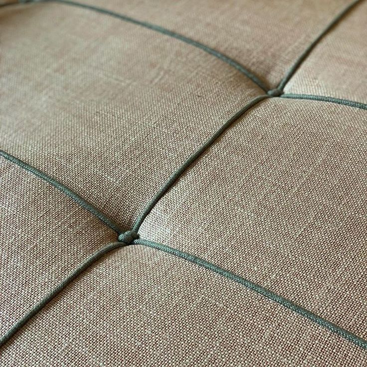 an upholstered cushion with green lines on it