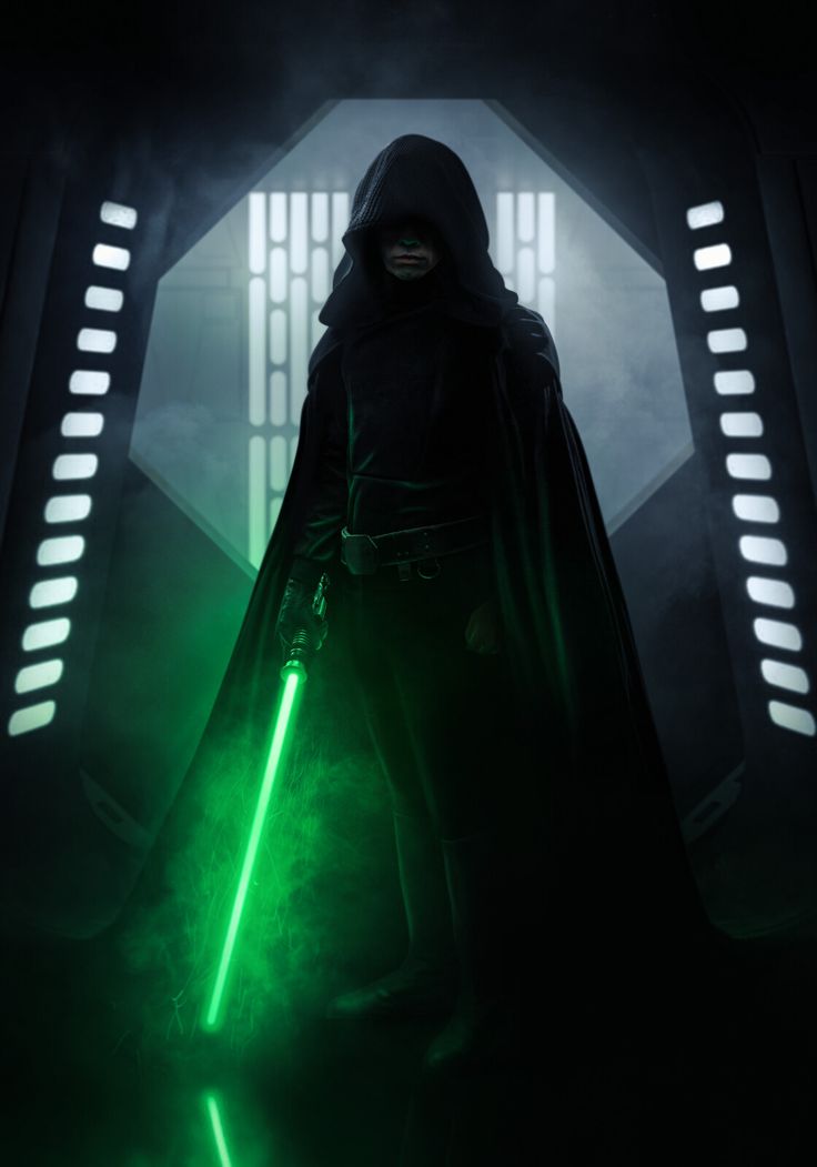 darth vader standing in the dark with green lights on his face and cape