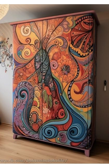 an artisticly painted cabinet in the corner of a room