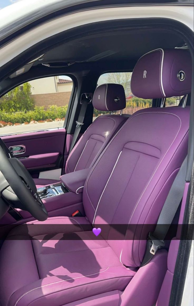 the interior of a car with purple leather seats