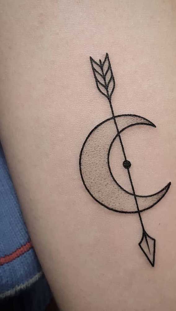 an arrow and crescent tattoo on the thigh