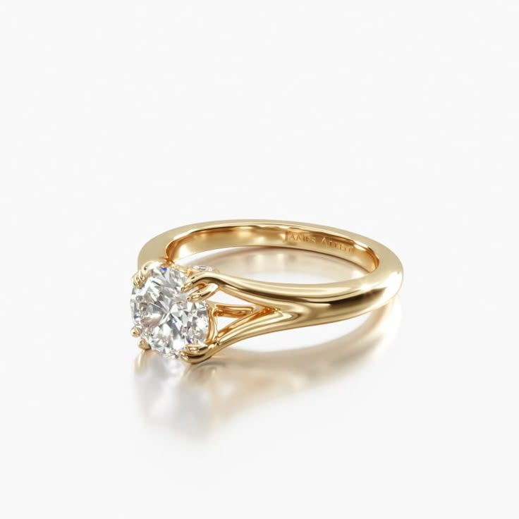 a yellow gold engagement ring with a round diamond in the center, on a white background