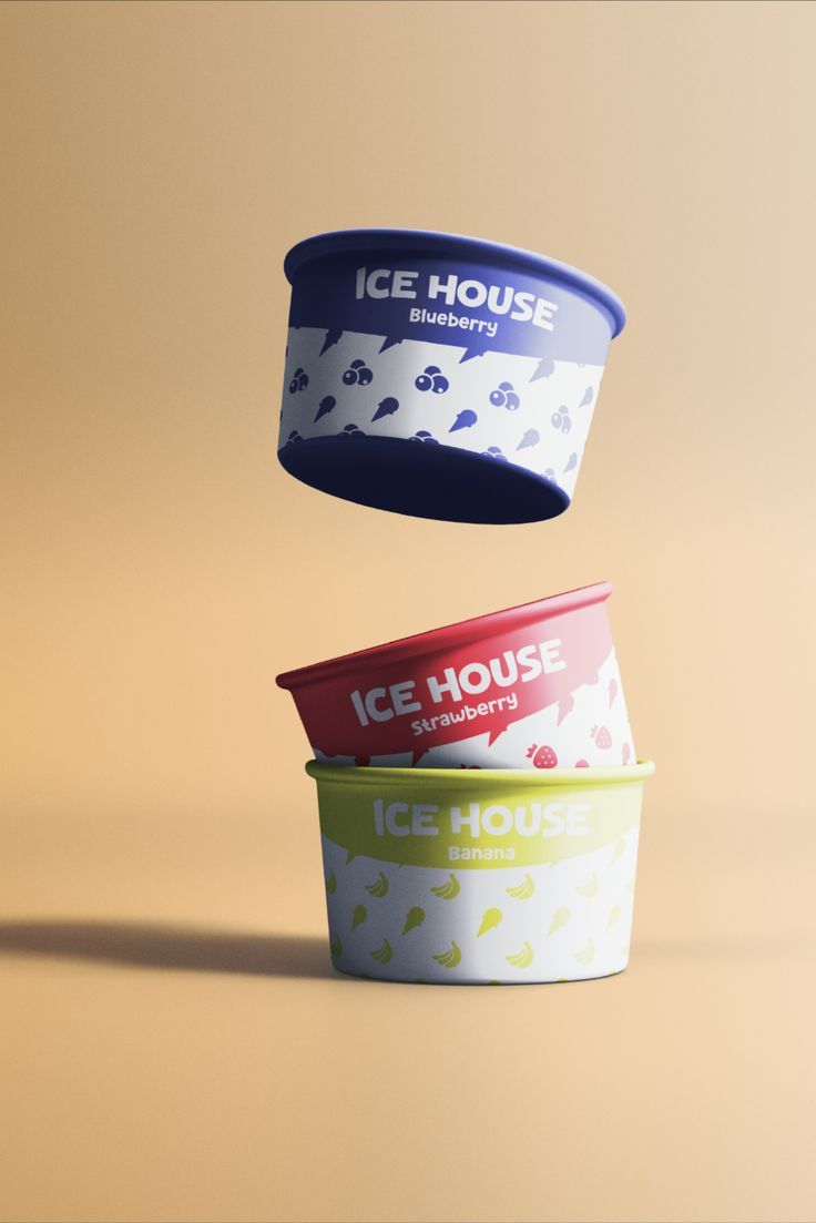 three ice cream containers flying in the air with one container upside down on its side