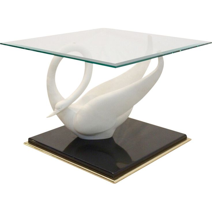 a glass table with a white swan on it's base and a black base