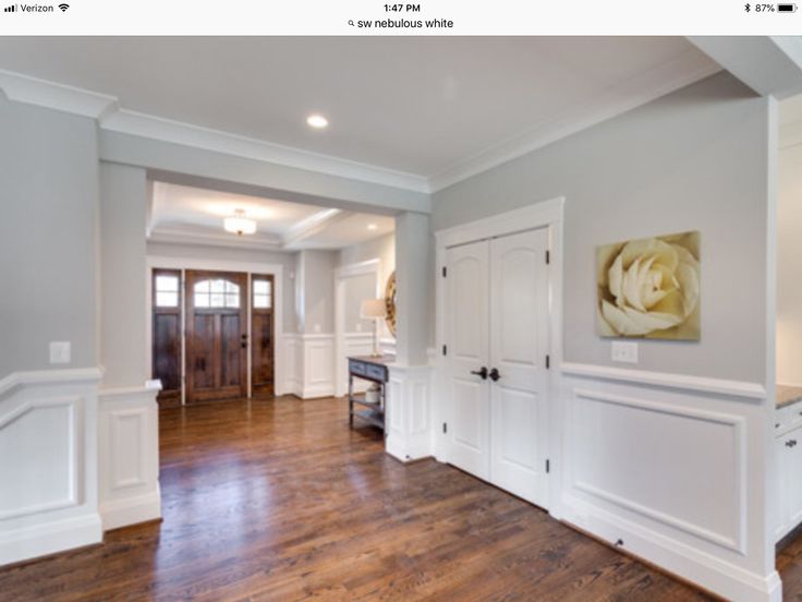 an empty living room with hard wood flooring and white trim on the walls, along with wooden floors