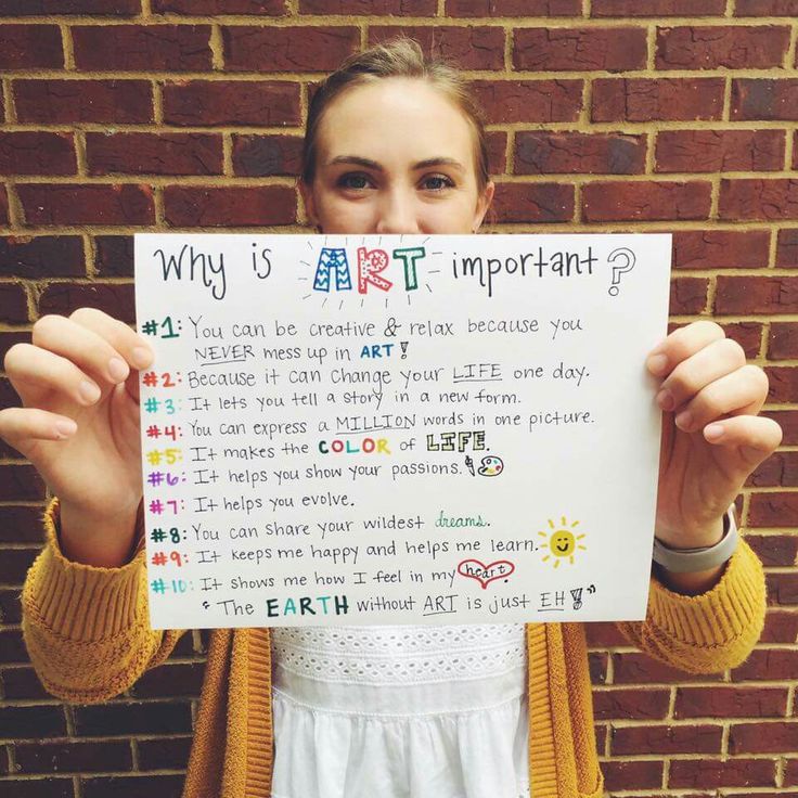 a woman holding up a piece of paper with writing on it that says, why is art important?