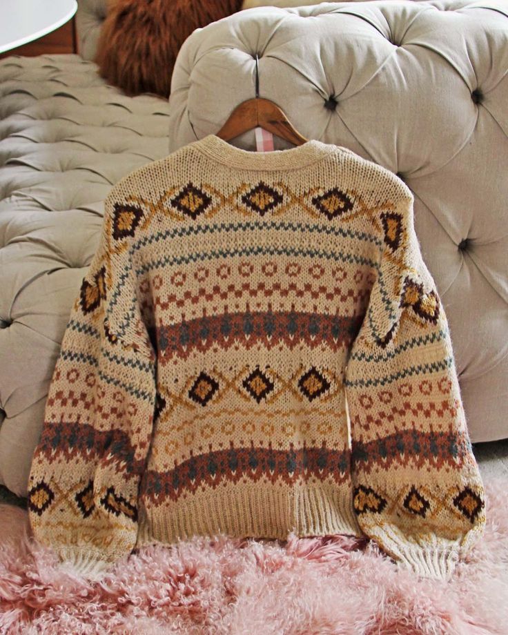 The softest thick & cozy knit pairs with Nordic & Fair Isle designs, a toggle button-up front, v-neck bust & oversized fit. Color: Sand & multi Acrylic blend Imported Hand wash cold Small Med Large Bust 44 46 48 Waist 44 46 48 Hips 44 46 48 Length 26 26 26 Bust, waist, and hip measurements are a total circumference. Length is measured from the top of the sweater to the hem. Measurements are an estimate. Big Cozy Sweaters, Sweaters For Winter, Vintage Knit Sweaters, Nordic Winter Outfits, Snowy Winter Outfits, Cozy Sweater Aesthetic, Cabincore Fashion, Grandma Sweaters, Cute Christmas Sweaters