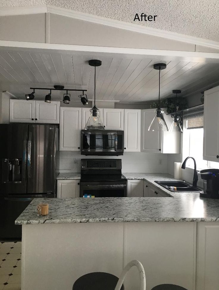 an empty kitchen with white cabinets and black appliances in the center, before and after remodeling