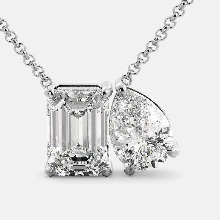 Our Toi et Moi Diamond Necklace. This particular necklace features a stunning emerald-cut Diamond and a pear-shaped Diamond, set side-by-side in a delicate prong setting. The contrast between the two shapes is both eye-catching and elegant. Features: Diamond (G/VS1) 0.55ct or 4.5ct Two-stone design 14K white, yellow, or rose gold Adjustable chain Secure lobster claw clasp Benefits: GIA Diamond Certificate for 4.5 ct Helps focus your energy and amplify your intentions Valuable investment Highest Classic White Gold Emerald Necklace With Diamond Accents, Luxury Pear-shaped Emerald Necklace In White Gold, Formal White Gold Pear-shaped Emerald Necklace, Luxury Pear-shaped White Gold Emerald Necklace, Elegant Teardrop Emerald And Diamond Necklace, Formal Platinum Necklace With Emerald Cut, Elegant White Gold Teardrop Emerald Necklace, Formal Brilliant Cut Emerald Pendant Necklace, Classic Emerald Pendant Necklace With Diamond Accents