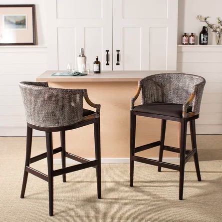 two bar stools sitting next to each other in front of a counter