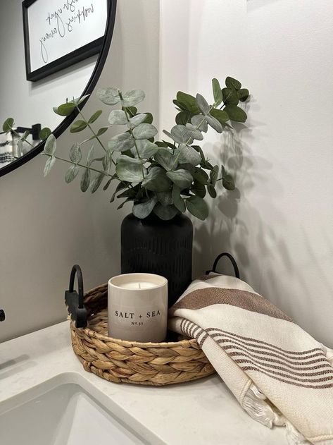 a bathroom sink with a basket and towel on it