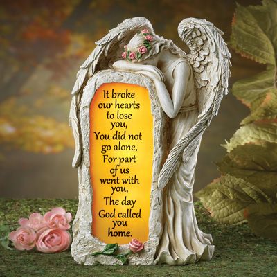 an angel figurine with a poem written on the side and flowers around it