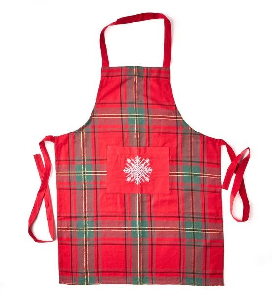 a red plaid apron with a snowflake on the front and white snowflake on the back