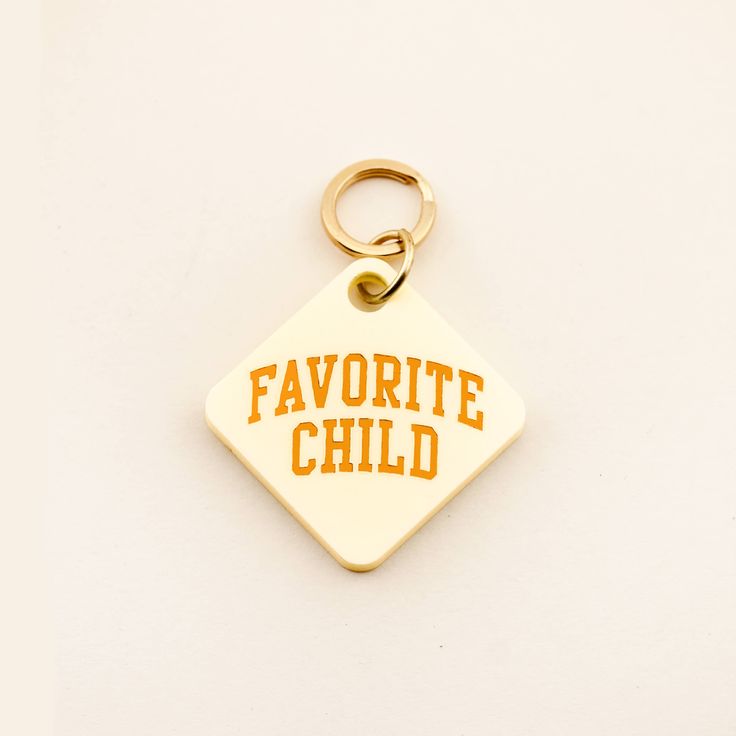 a keychain with the words favorite child written on it and an orange outline