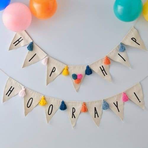 a birthday banner that says happy hooray with balloons and streamers in the background