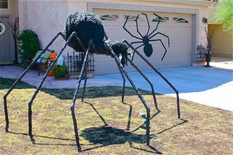 a large spider sculpture in front of a house