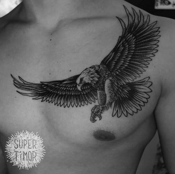 a man's chest with an eagle tattoo on it and the words supertemp written