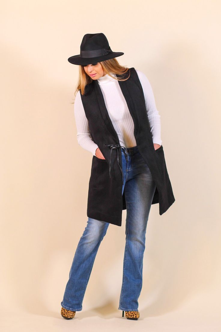 Add this timeless piece to your wardrobe! This long vest is perfect worn over sweaters or turtlenecks for an extra layer of warmth. -Color: Black -Shawl collar, sleeveless -Front patch pockets -Leather drawstring closure -Very warm -Lined -Content: 100% Polyester Lining: 100% Cotton -Hand wash/ Dry flat -Imported -Runs true to size -Model is 5'5" 36-30-40 and wearing a size Small Fall Sweater Vest With Pockets For Layering, Sleeveless Vest For Cold Weather In Fall, Fall Layering Sweater Vest With Pockets, Trendy Winter Vest For Everyday Wear, Chic Black Sweater Vest For Fall, Fall Workwear Vest With Pockets, Trendy Winter Sweater Vest For Work, Trendy Winter Workwear Sweater Vest, Trendy Everyday Fall Vest