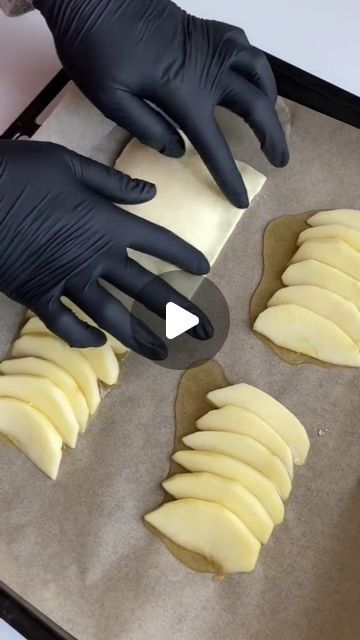 a person in black gloves is making some food