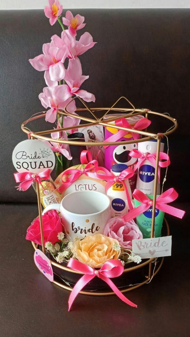 a basket filled with pink flowers on top of a table