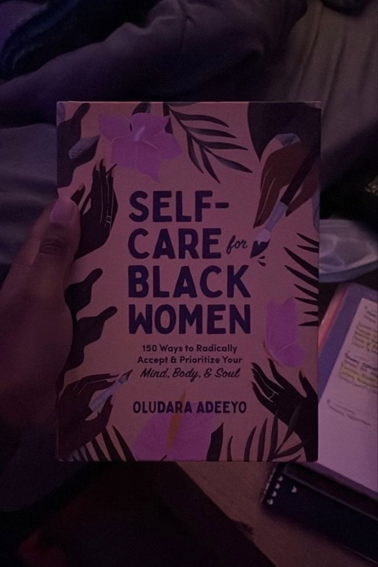 someone holding up a book about self - care for black women