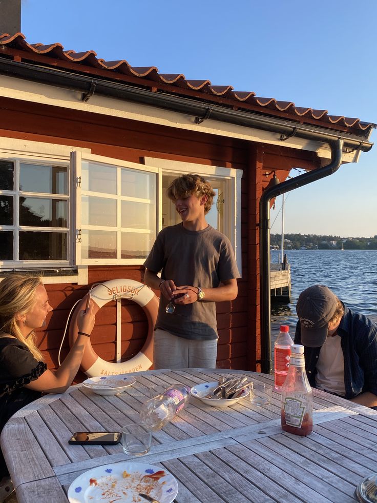 three people sitting at a table on a boat