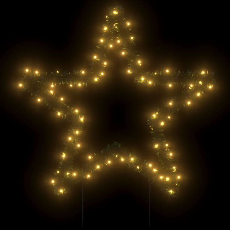 a lighted star shaped object in the dark