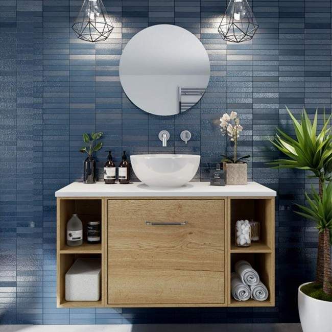 a bathroom vanity with a round mirror above it