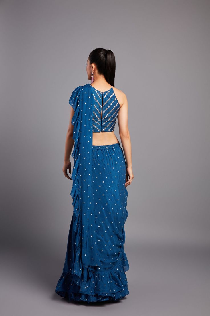 Georgette pre-draped ruffle saree paired with a zardozi and glass beads embroidered halter blouse From Chamee and Palak 's Alora collectionDELIVERY TIMEPlease allow 8-12 weeks for your outfit to arriveFABRIC DETAILSGeorgette and raw silkProfessional cleaning only Semi-stitched Sleeveless Georgette Pre-draped Saree, Festive Draped Choli With Ruffles, Festive Draped Ruffle Choli, Festive Draped Ruffled Choli, Festive Draped Ruffles Choli, Unstitched Blouse Draped Lehenga In Georgette, Draped Georgette Lehenga With Unstitched Blouse, Georgette Draped Lehenga With Unstitched Blouse, Embellished Georgette Pre-draped Saree For Navratri