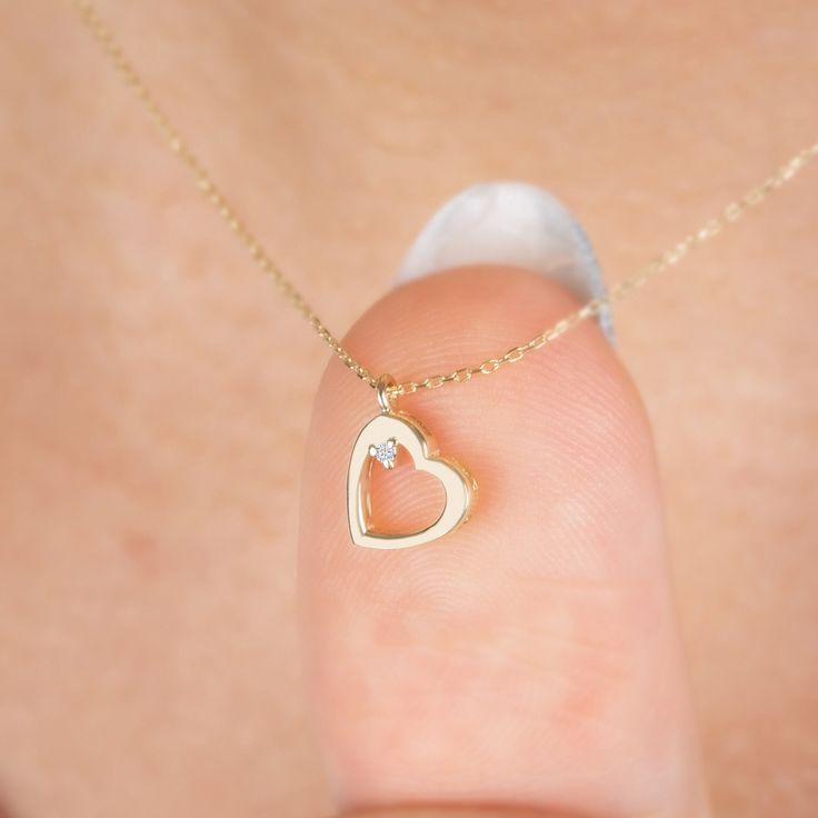 "Diamond Dangle Heart Necklace in 14k Solid Gold, Real Diamond Open Heart Necklace, Minimalist Heart Necklace, Heart Talisman, Valentine Gift F E A T U R E S * Made to Order. * Gold KT: 14K * Choice of Gold Color: Yellow Gold, Rose Gold, White Gold * Gem Stone: Genuine Diamond * Diamond-Cut: Round * Diamond Carat: 0.01 ct. * Pendant Height: 9,50 mm / 0.37 inch * Pendant Width: 7,50 mm / 0.30 inch * Diamond Color-Clarity: G.VS Color, SI Clarity * Length: 14\", 16\", 18\", 20\", 22\", 24\" * Setting Type: Bezel Setting * Ready to Ship in 1-3 Business Days * 100% US sourced * 2 Years Warranty * Free Express International Shipping * Free returns within 14 days from the order date We loved making our jewelry with special designs for your special moments. Wishing you to share the joy on a perfec Heart Shape Pendent Gold, Gold Heart Necklace With Diamonds, 14k Gold Heart Charm Necklace For Wedding, Fine Jewelry Heart Necklace With Birthstone For Wedding, Delicate Jewelry With Heart Charm For Mom, Delicate Heart Charm Jewelry For Mom, Delicate Jewelry With Heart Charm For Mom's Gift, Delicate Heart Charm Jewelry As Gift For Mom, Wedding Heart Necklace With Birthstone In Fine Jewelry Style