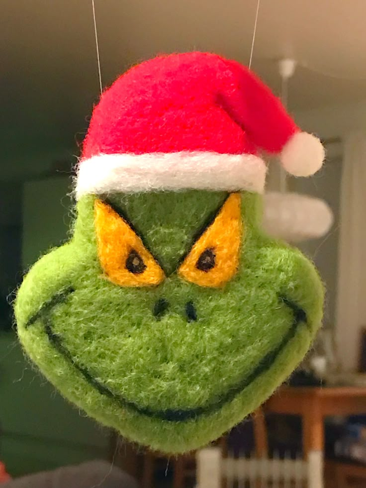 an ornament with a grin face wearing a santa hat