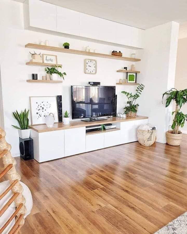 a living room with wooden floors and white walls