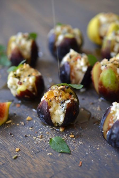 figs with cheese and herbs on a wooden table