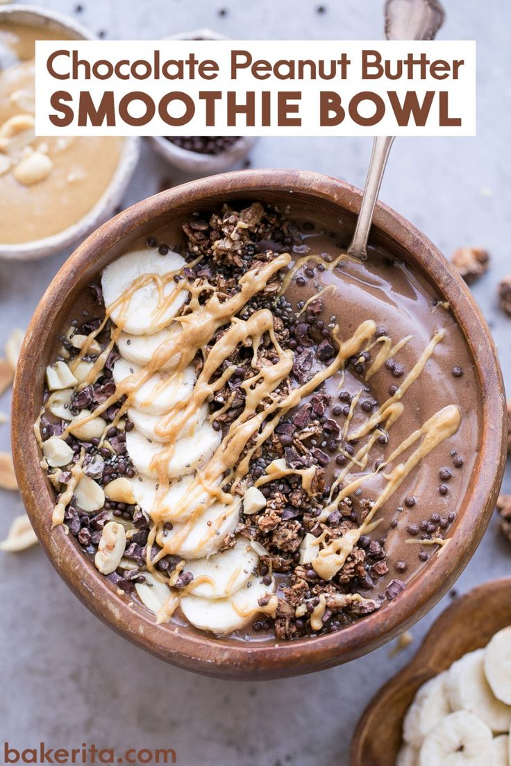 a bowl filled with ice cream, bananas and chocolate on top of a table next to other