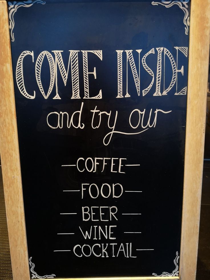 a chalkboard sign that says come inside and try our coffee food beer wine cocktail