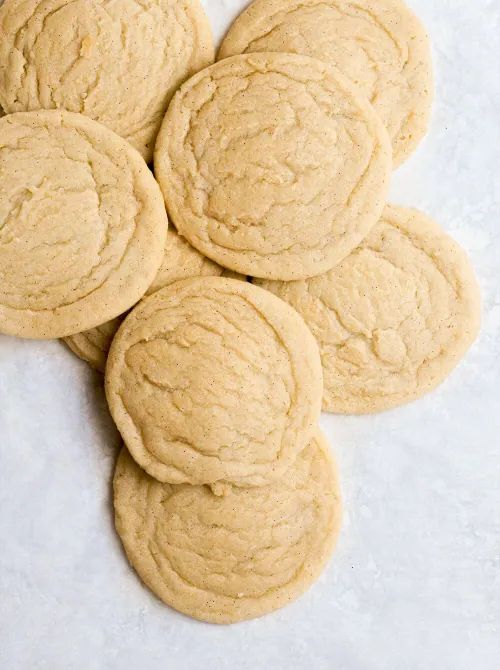 several cookies sitting on top of each other in front of a white background with one cookie missing