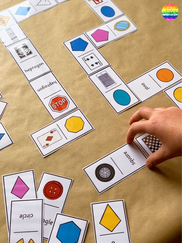 a child's hand is playing with matching cards