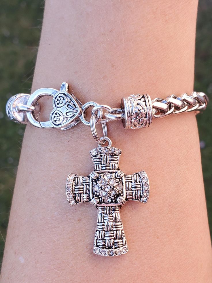 Pretty crystal cross bracelet  the cross is made of Antique silver plated, lead~free, nickel~free, cadmium~free   Stainless steel braided bracelet fitting up to an 8" wrist  Quantity: 1 Bracelet as shown     Thank you for visiting my shop! Nickel Free Silver Cross Bracelets, Nickel-free Silver Cross Bracelets, Silver Nickel-free Cross Bracelet, Silver Cross Bracelet, Spiritual Style, Spiritual Silver Cross Bracelet, Nickel-free Silver Cross Rosary Bracelet, Spiritual Silver Charm Bracelet With Cross, Spiritual Silver Cross Charm Bracelet, Silver Cross Rosary Bracelet