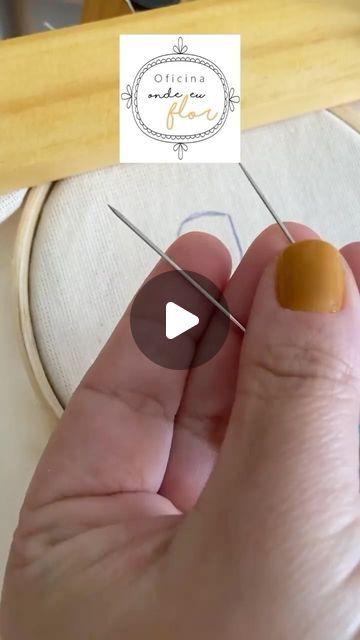 a person is holding two needles in front of a sewing machine with the needle pointed through it