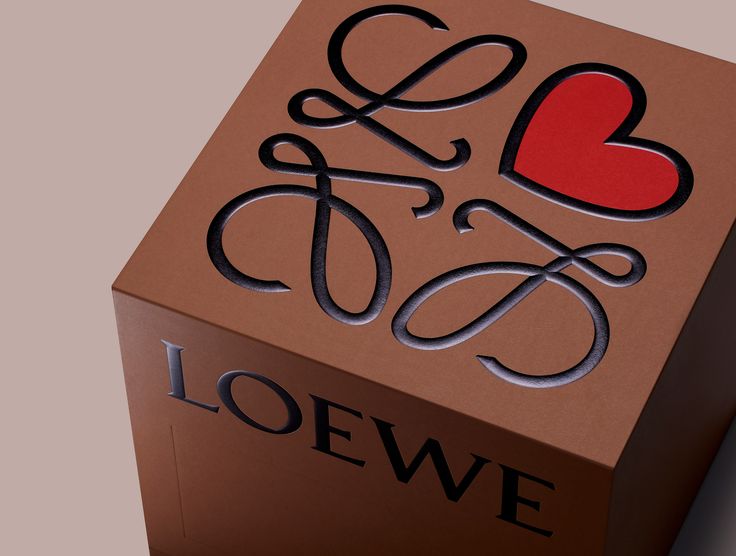 a brown box with black lettering and a red heart on the top that says love