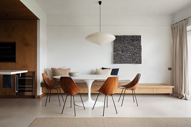 a dining room table with chairs and a bench