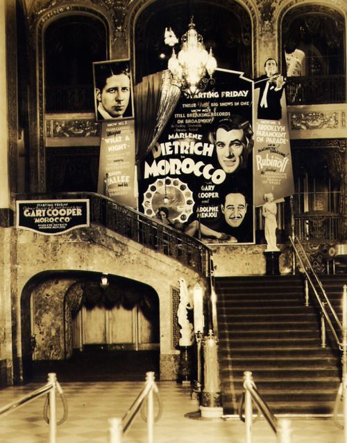 an old building with stairs and posters on the wall