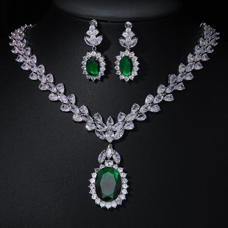 Experience the epitome of elegance with our Luxury Emerald Bridal Jewelry Sets. These exquisite pieces feature captivating green emerald-like stones crafted from AAA Cubic Zirconia, meticulously set in a pendant necklace and coordinating earrings. Designed to enhance your allure at any special occasion, from weddings to glamorous parties and elegant dinner events, these sets embody a timeless sophistication. Style: TRENDY Shape\pattern: Geometric Occasion: Wedding Metals Type: Copper Alloy Mater Emerald Jewelry Aesthetic, Emerald Bridal Jewelry, Emerald Green Jewelry Set, Green Jewellery Set, Emerald Jewelry Necklace, Emerald Necklace Set, Emerald Jewelry Set, Green Emerald Necklace, Emerald Green Jewelry