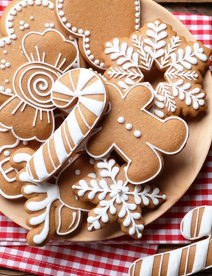 gingerbread cut out cookies on a plate with candy canes