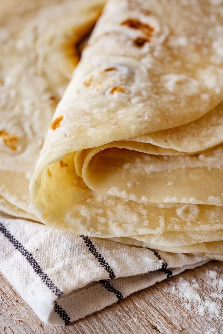 some tortillas are stacked on top of each other