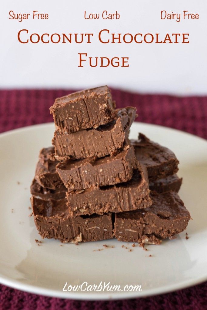 chocolate fudge cut into squares on a white plate with the words low carb coconut chocolate fudge