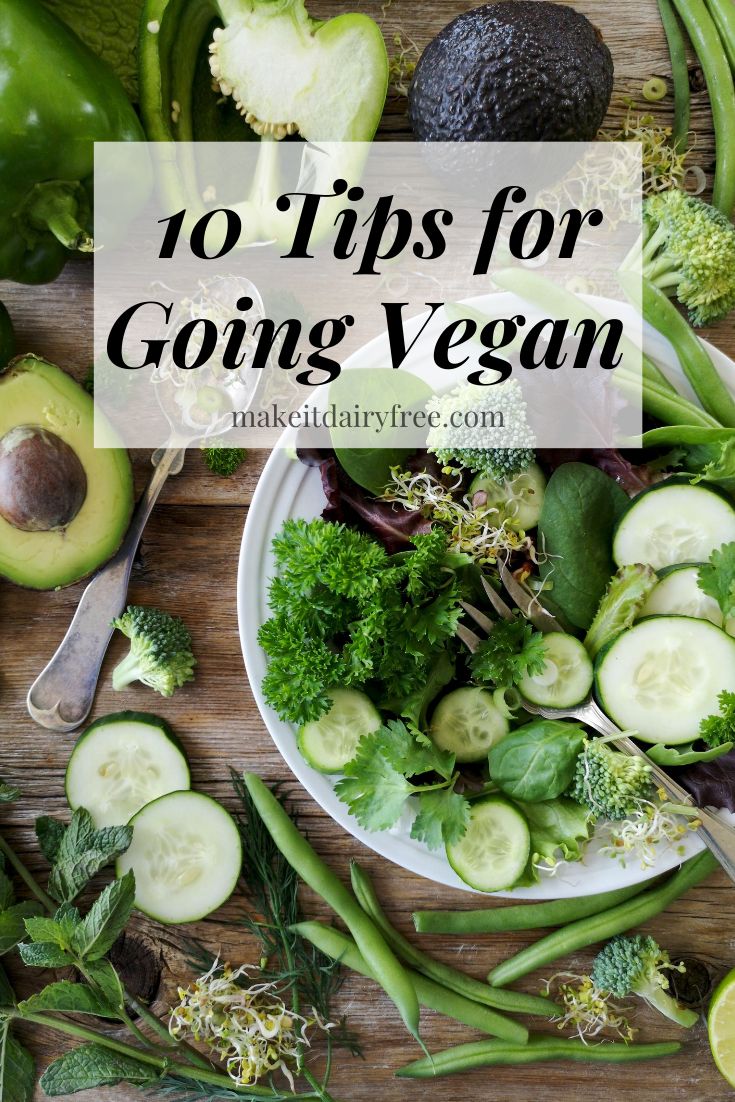 an assortment of fresh vegetables on a plate with the title overlay reads 10 tips for going vegan