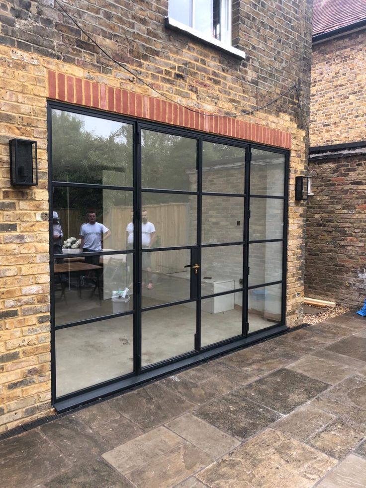 an outside view of a brick building with glass doors