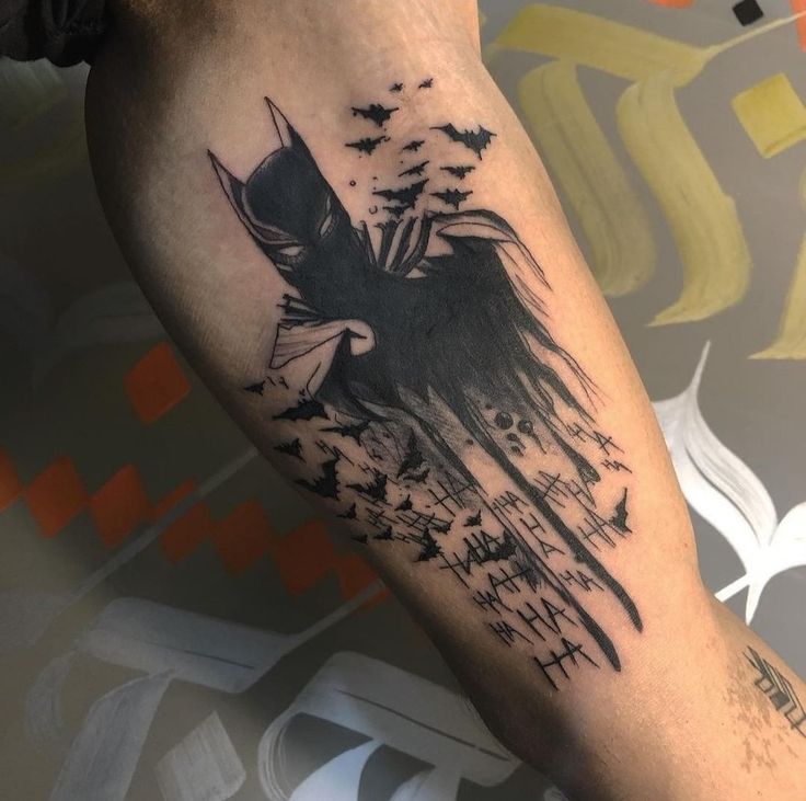 a man's leg with a black and white tattoo design on it, which has birds flying in the sky