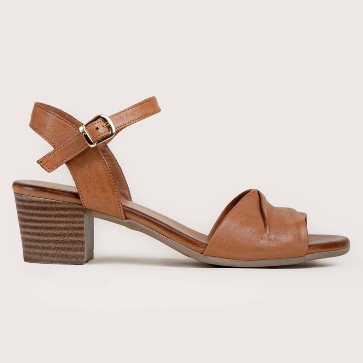 Complete your wardrobe with these comfortable mid-heel sandals. Astoria offers a padded footbed with beautiful folded leather details. The 1 1/2" heel height gives just enough height for all day wear. Genuine leather upper Metal buckle detailing Padded insole 1 1/2" rubber heel and sole Style Name: ASTORIA-TAN Waterproof Slippers, Mid Heel Sandals, Water Shoes, Street Chic, Rubber Heels, Mid Heel, Kids Sneakers, Metal Buckles, Mens Shoes Sneakers